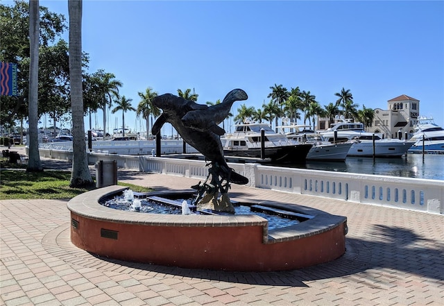 view of home's community featuring a water view and a boat dock