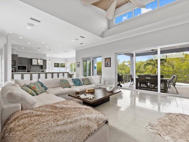 living room featuring visible vents, baseboards, a towering ceiling, and recessed lighting