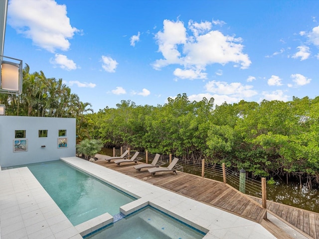 view of pool with a pool with connected hot tub and a patio