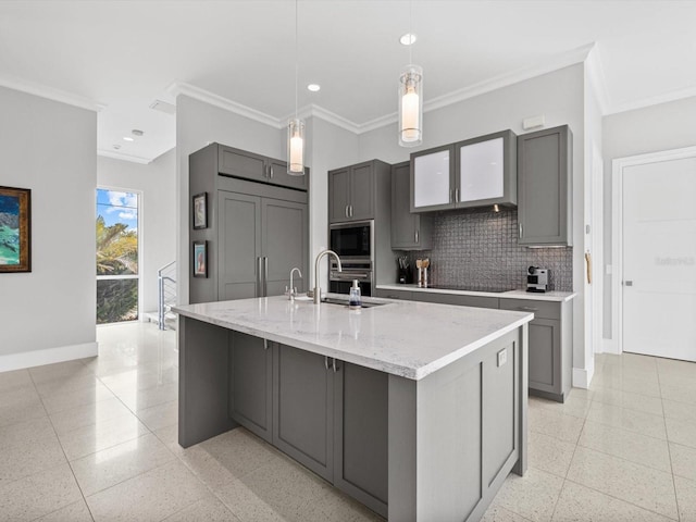 kitchen with built in microwave, baseboards, a sink, and gray cabinetry