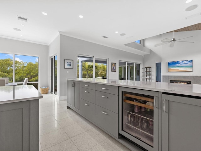 bar featuring light speckled floor, wine cooler, recessed lighting, visible vents, and ornamental molding