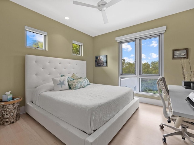 bedroom featuring light wood-style flooring, baseboards, and ceiling fan