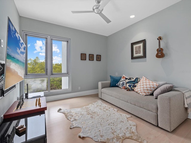 living room featuring ceiling fan, baseboards, and recessed lighting