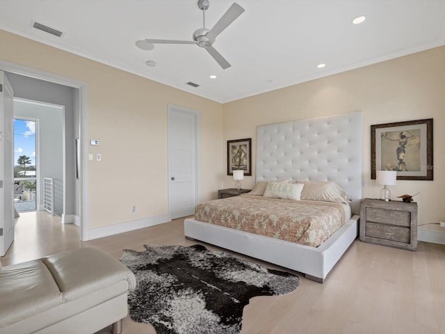 bedroom with light wood finished floors, baseboards, and visible vents