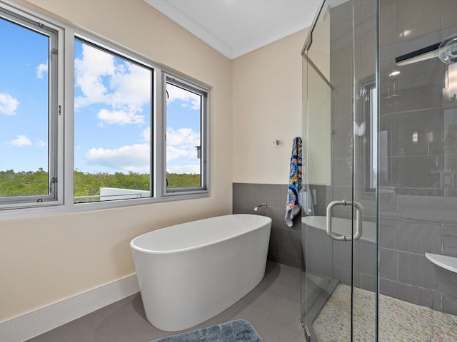 full bath featuring a stall shower, ornamental molding, and a soaking tub