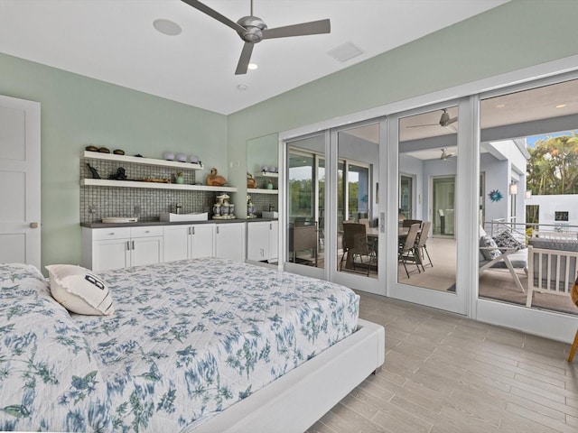 bedroom with access to exterior, ceiling fan, and visible vents