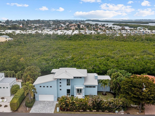 aerial view with a water view and a forest view