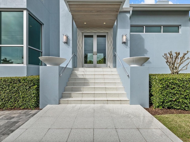 doorway to property featuring french doors and stucco siding