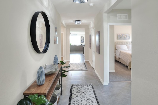 hall featuring light tile patterned floors