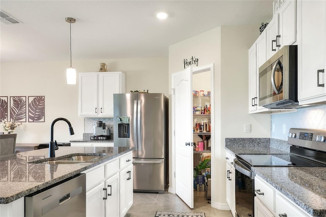 kitchen with backsplash, decorative light fixtures, stainless steel appliances, white cabinetry, and sink