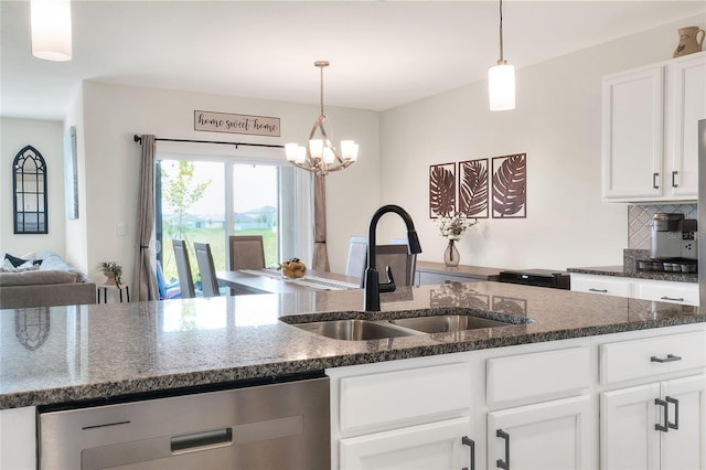 kitchen featuring white cabinetry, sink, stainless steel dishwasher, and decorative backsplash