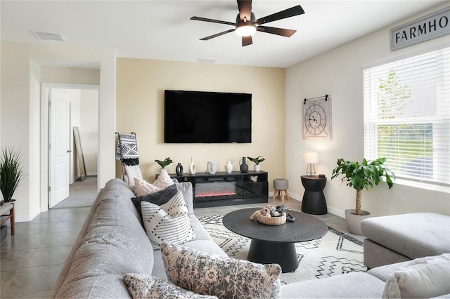 living room featuring ceiling fan and tile patterned flooring