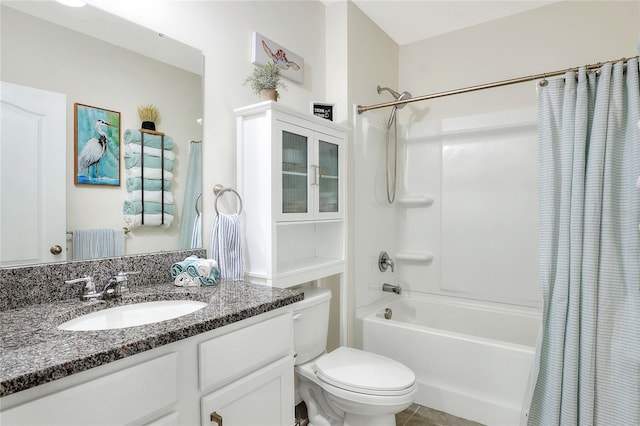 full bathroom with tile patterned floors, shower / bath combo, toilet, and vanity