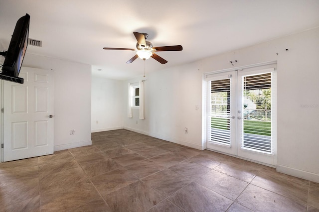 spare room featuring french doors and ceiling fan