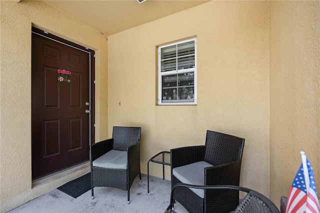 entrance to property featuring stucco siding