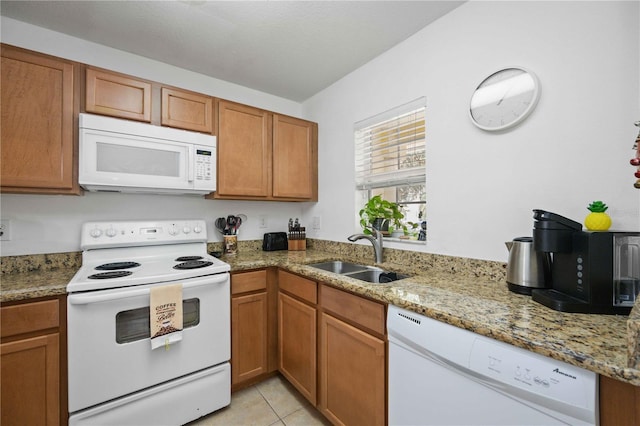 10959 Keys Gate Dr, Riverview, FL 33579 - kitchen with brown cabinets, white appliances, light stone countertops, and a sink