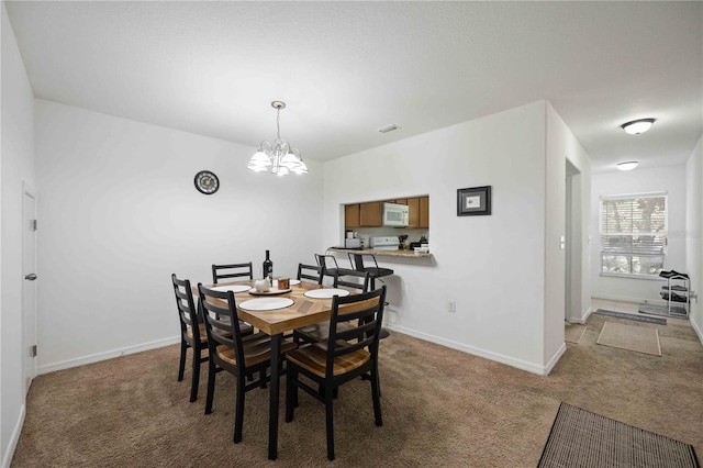 10959 Keys Gate Dr, Riverview, FL 33579 - carpeted dining area featuring baseboards, visible vents, and a notable chandelier