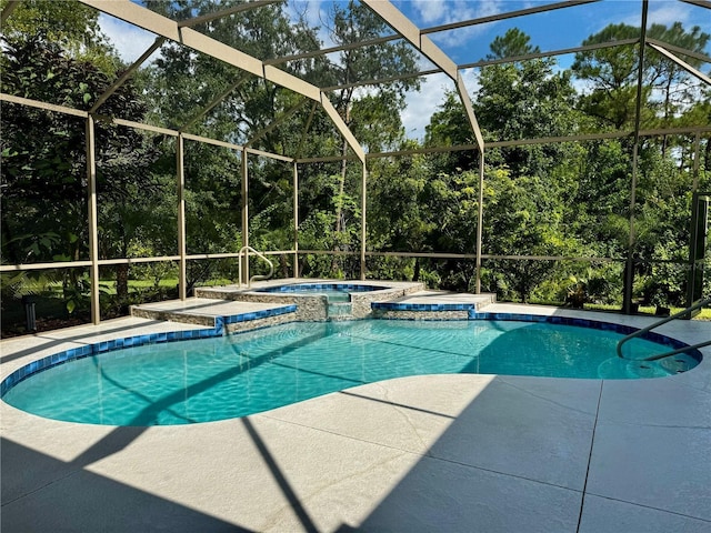 view of swimming pool featuring a patio, a lanai, and a pool with connected hot tub