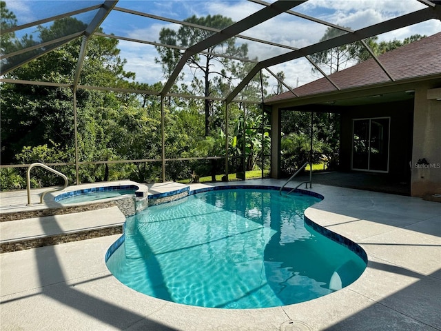 view of swimming pool with a patio area, a lanai, and a pool with connected hot tub