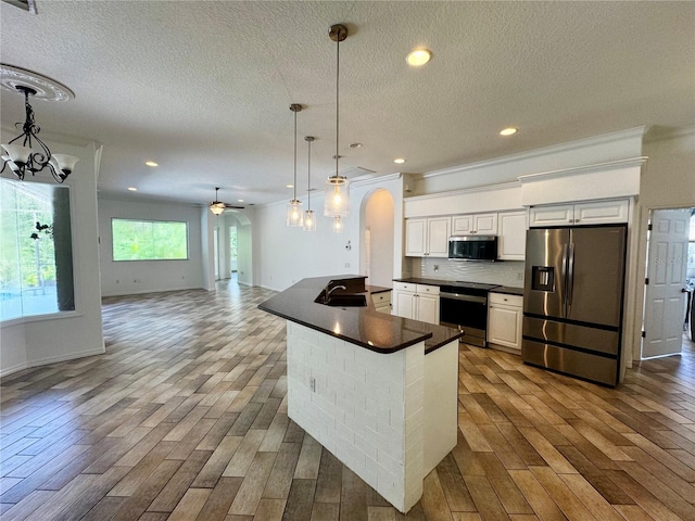 kitchen featuring white cabinets, wood-type flooring, sink, and stainless steel appliances