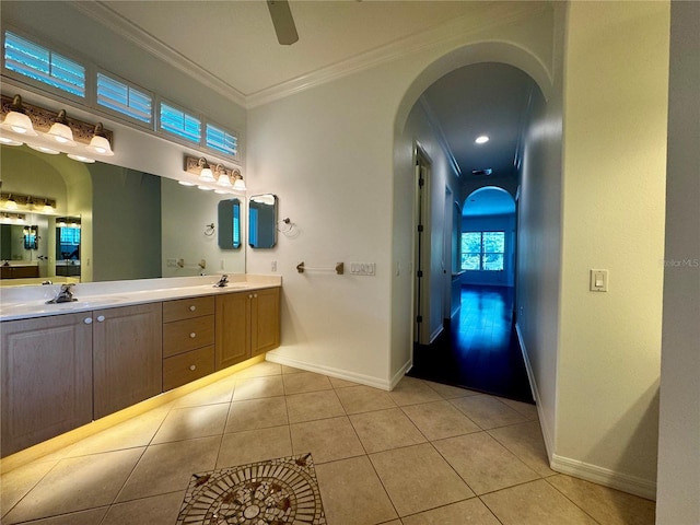 bathroom with double vanity, tile patterned flooring, a sink, and crown molding