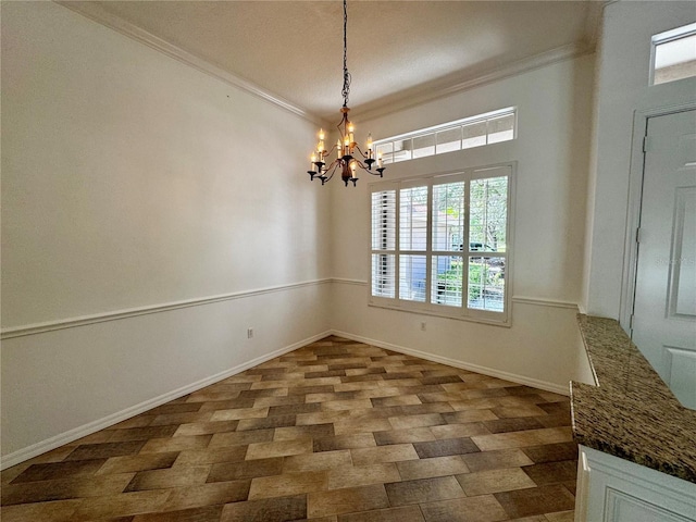 unfurnished dining area with baseboards, ornamental molding, and a notable chandelier