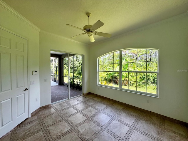 interior space featuring tile patterned floors, a textured ceiling, crown molding, and ceiling fan