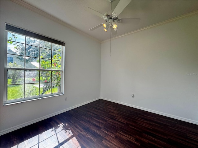 spare room featuring ornamental molding, wood finished floors, a ceiling fan, and baseboards