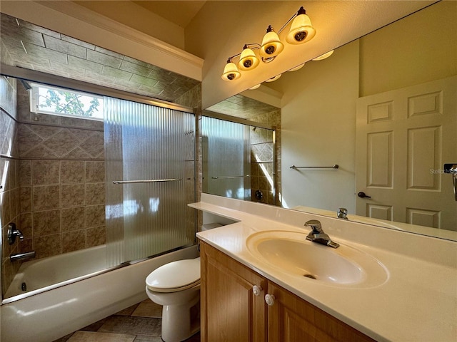 full bathroom featuring combined bath / shower with glass door, toilet, vanity, and tile patterned floors