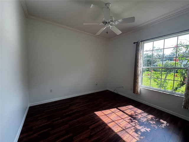 empty room with crown molding, dark wood finished floors, baseboards, and a ceiling fan