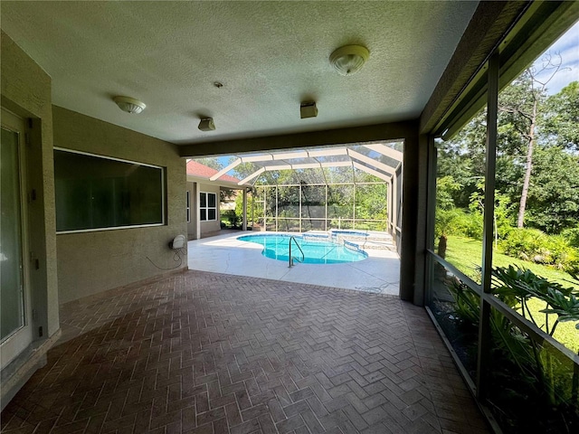 view of swimming pool featuring glass enclosure and a patio area