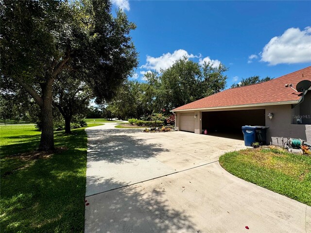 view of side of home with a garage and a yard