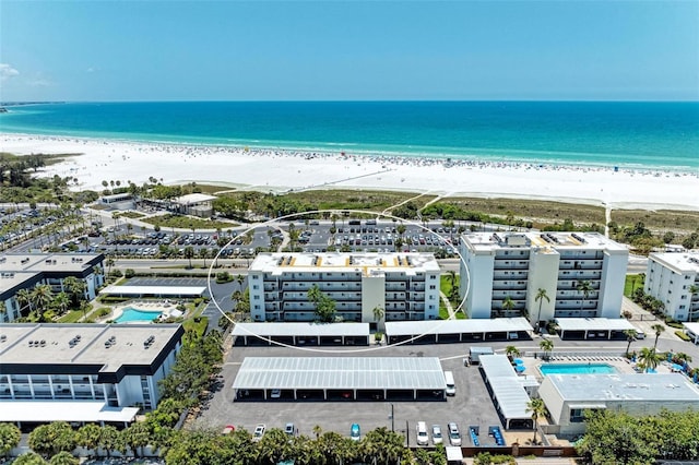 bird's eye view with a water view and a beach view