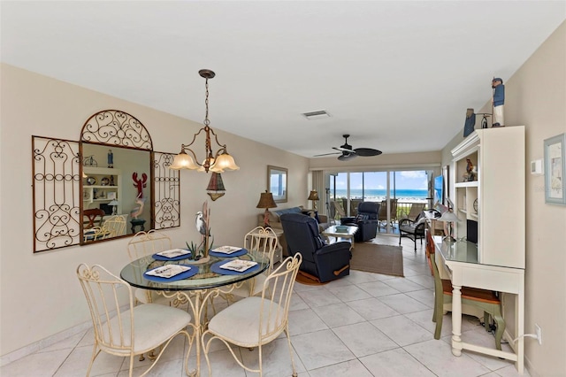 dining area featuring ceiling fan with notable chandelier, visible vents, and light tile patterned flooring