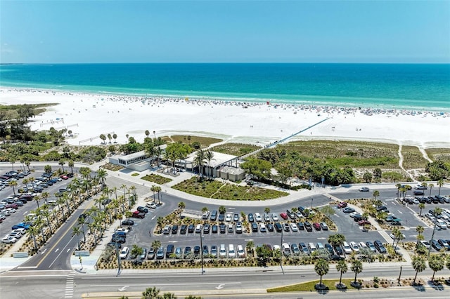 birds eye view of property featuring a water view and a beach view