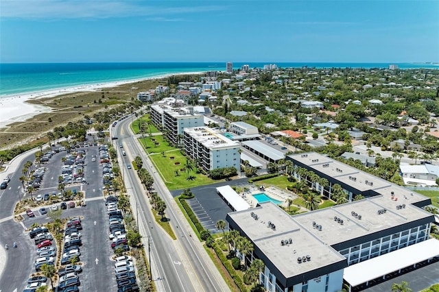 drone / aerial view featuring a water view and a view of the beach