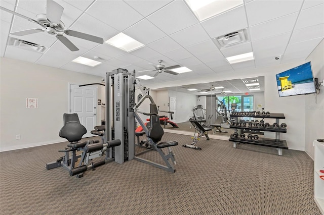 workout area with a paneled ceiling, visible vents, and a ceiling fan