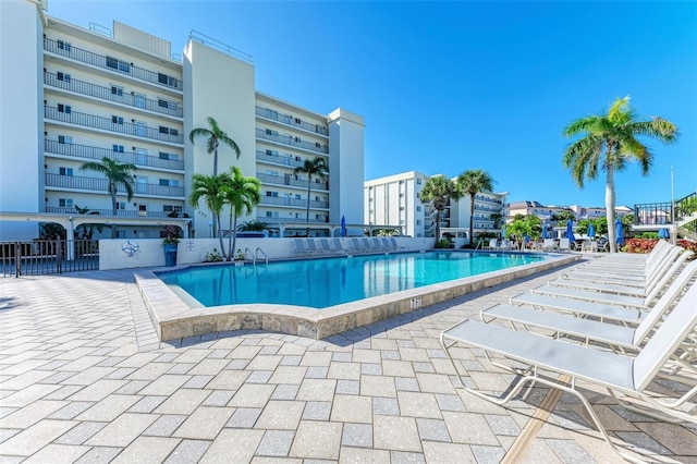 pool featuring a patio area and fence