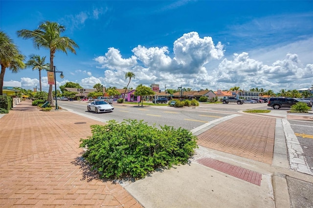 view of road with curbs, street lighting, sidewalks, and a residential view