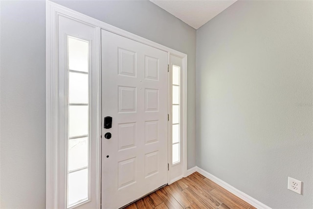 foyer entrance featuring plenty of natural light and light hardwood / wood-style floors