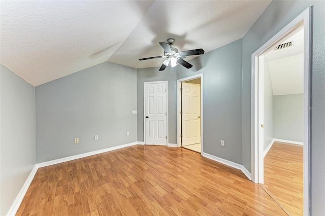 bonus room with vaulted ceiling, a textured ceiling, hardwood / wood-style flooring, and ceiling fan