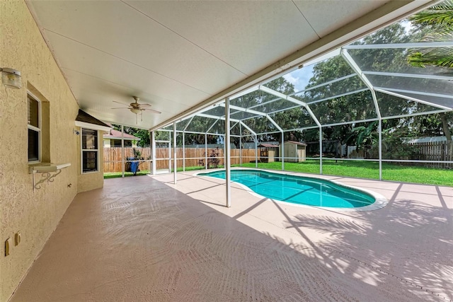 view of pool featuring a storage shed, a patio area, a lanai, and ceiling fan