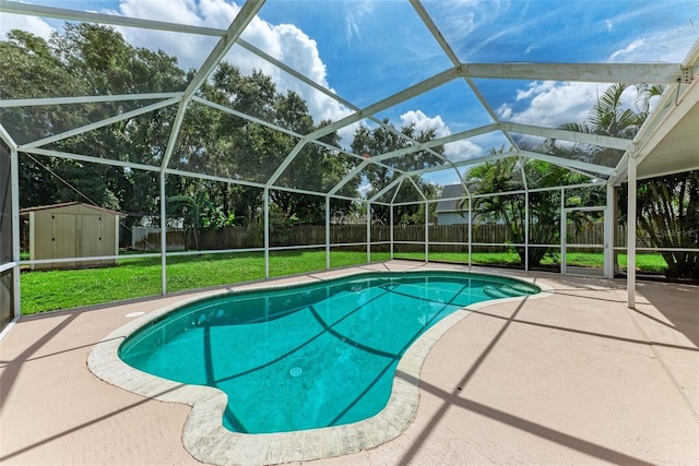 view of swimming pool featuring a storage unit, a lawn, a lanai, and a patio