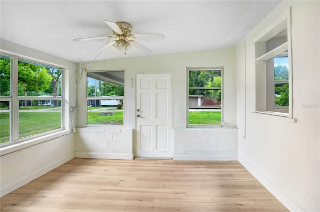 interior space with ceiling fan, lofted ceiling, and a healthy amount of sunlight