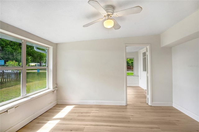 unfurnished room with light hardwood / wood-style flooring, ceiling fan, and plenty of natural light