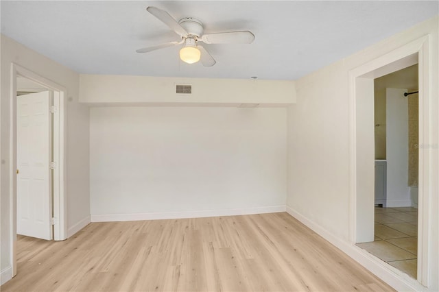 empty room featuring ceiling fan and light hardwood / wood-style flooring