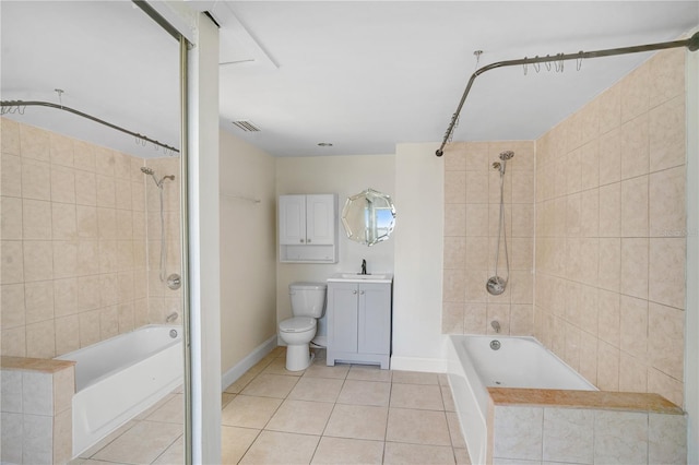 full bathroom featuring tile patterned flooring, toilet, vanity, and tiled shower / bath