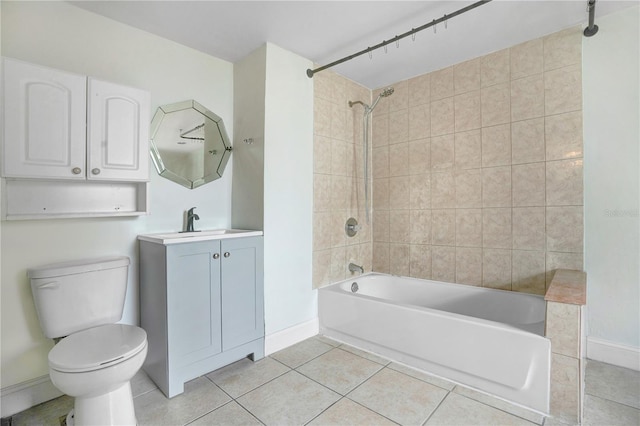 full bathroom featuring toilet, tiled shower / bath, vanity, and tile patterned floors