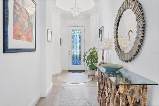 foyer entrance featuring light tile patterned floors, crown molding, and a chandelier