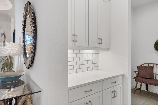 interior space featuring white cabinets, tasteful backsplash, and tile patterned floors